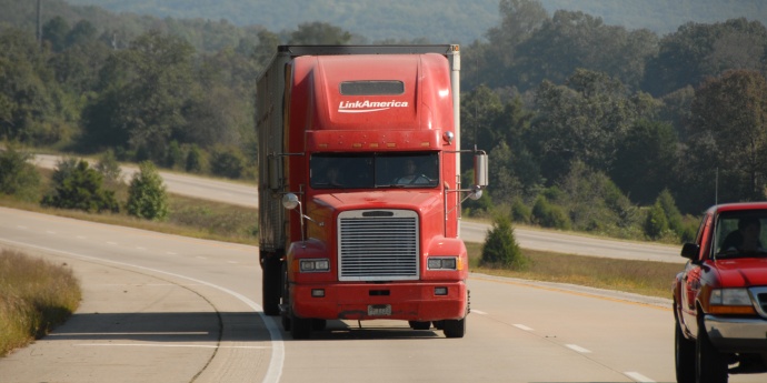 MCS - Red Truck Rounding Curve Forest Background Thumbnail