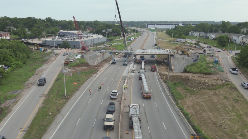 Girder installation project at bridge over a closed interstate with traffic being routed up and over the adjacent ramps