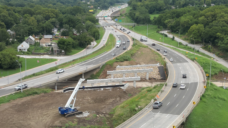 Ariel view of constructed bridge columns and bridge caps in median of active interstate